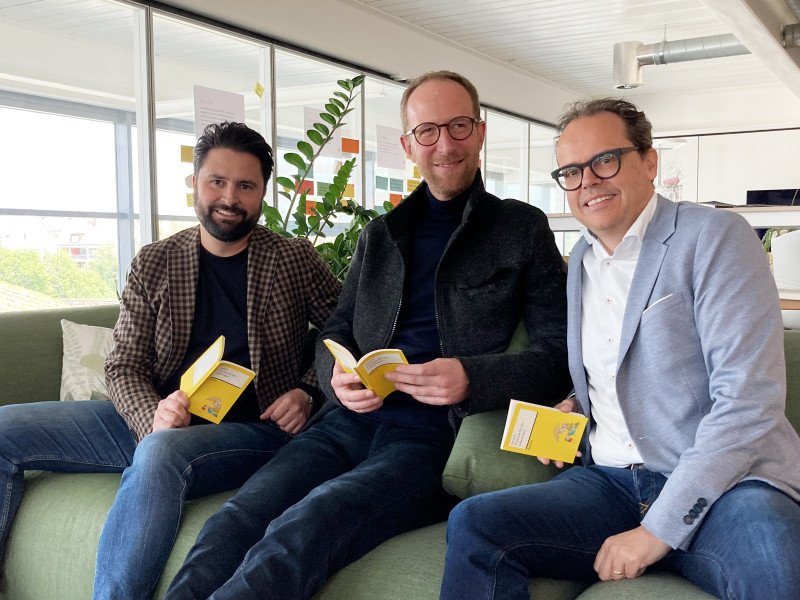 Drei Männer mit Buch